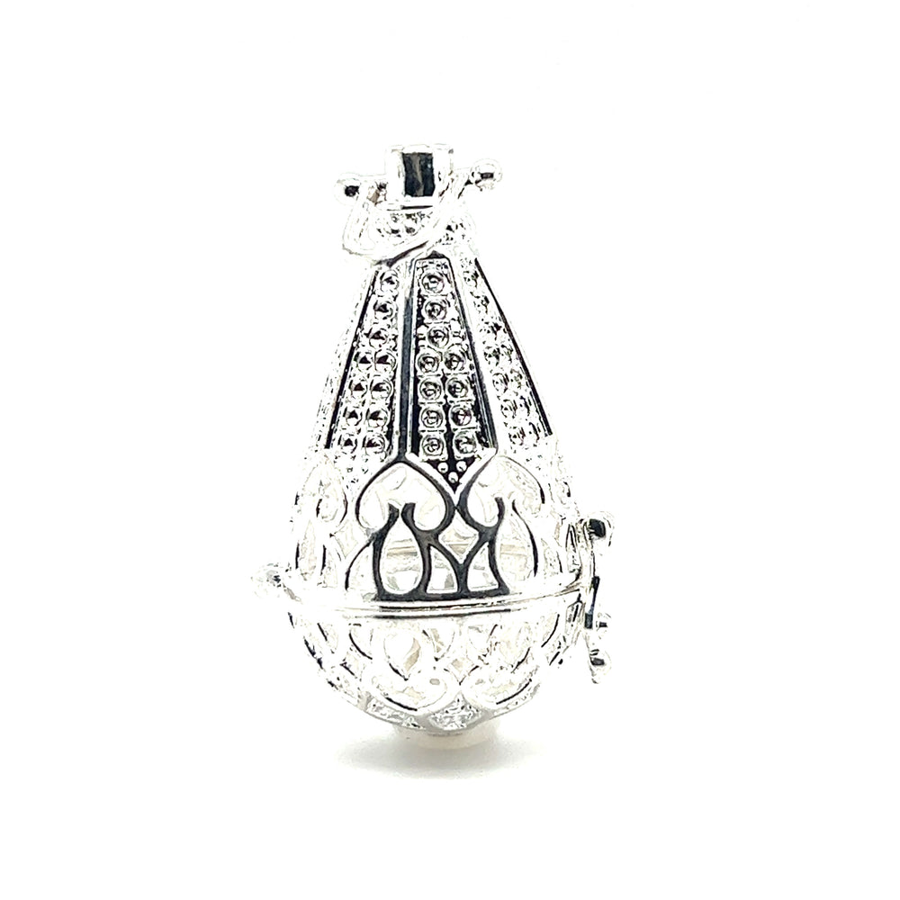 
                  
                    An ornate Super Silver Filigree Cage Pendant with precious gems on it, exuding a boho vibe.
                  
                