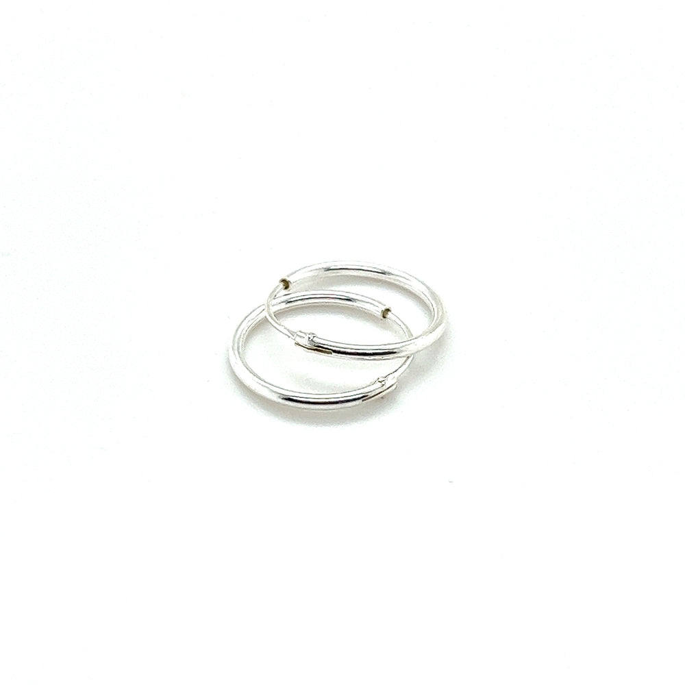 
                  
                    A pair of Super Silver 1.2mm Infinity Hoops on a white background.
                  
                