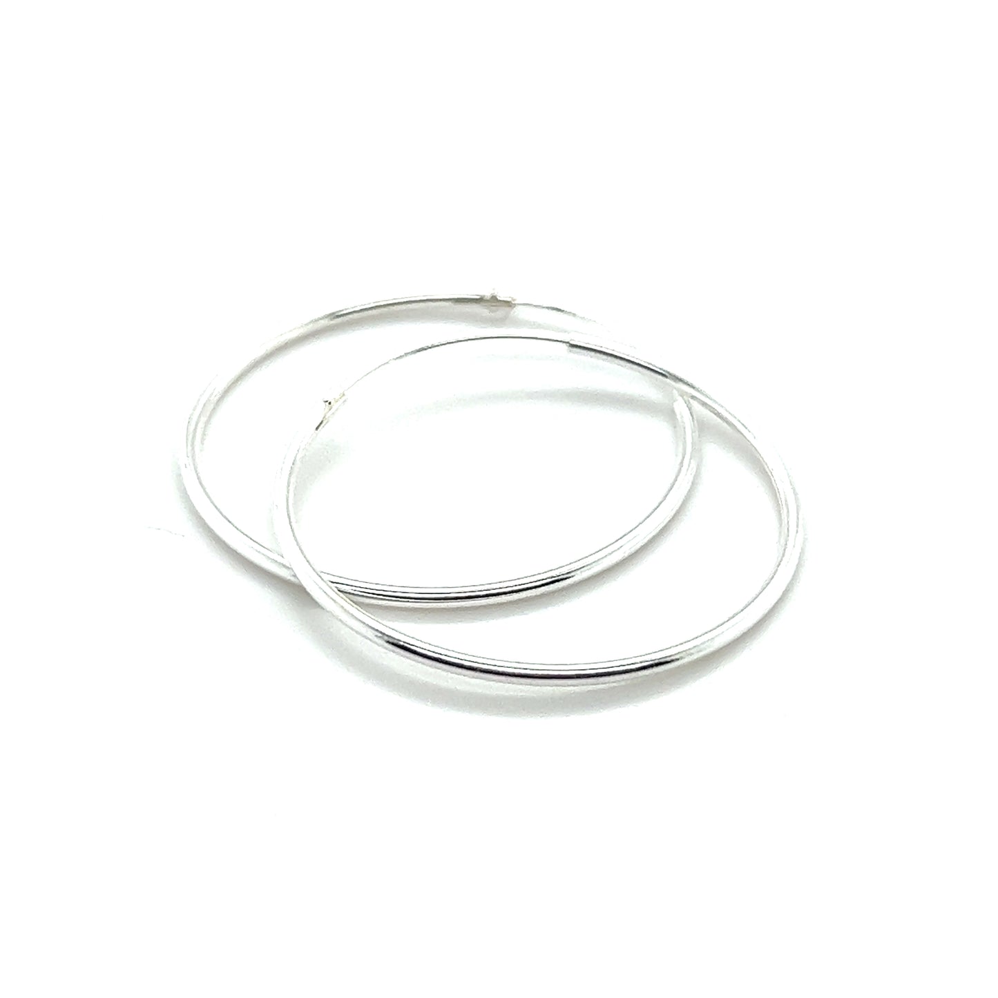 
                  
                    A pair of Super Silver's 1.2mm Infinity Hoops on a white background.
                  
                