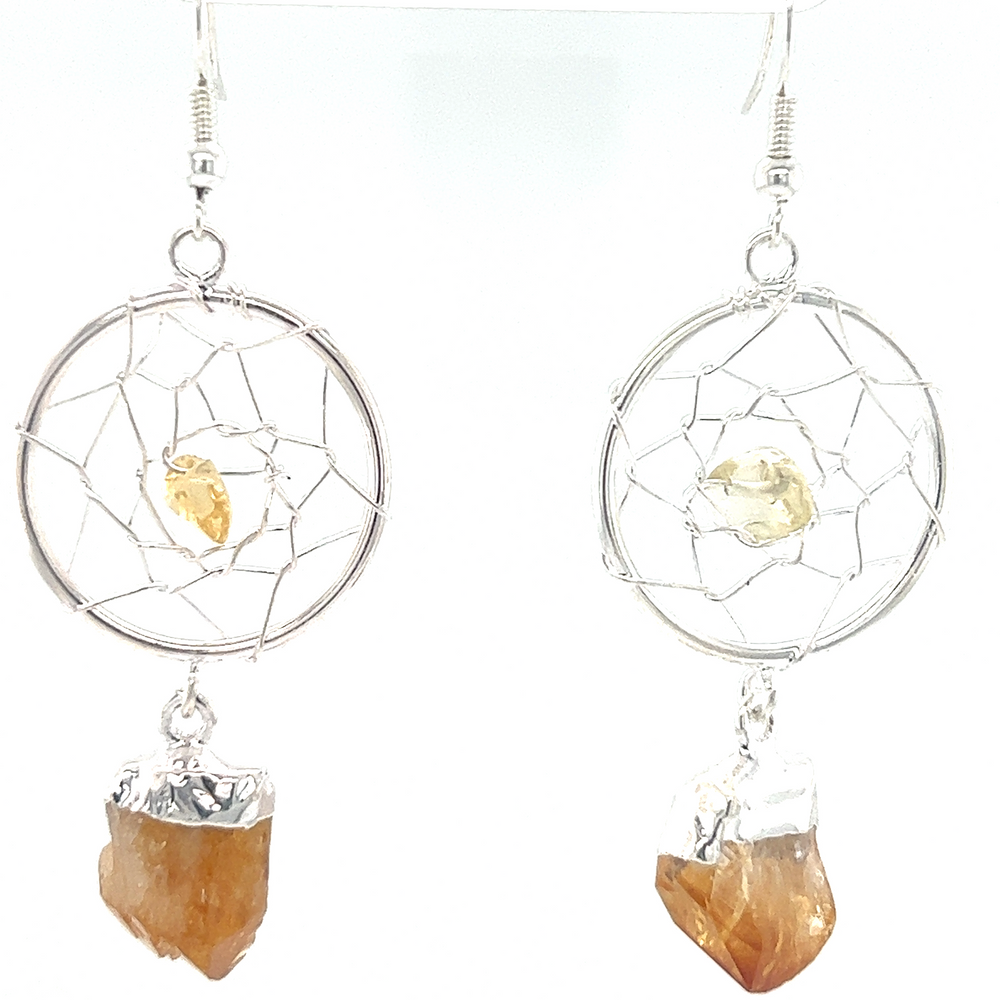 
                  
                    A pair of Super Silver Raw Crystal Dream Catcher Earrings with a yellow gemstone.
                  
                