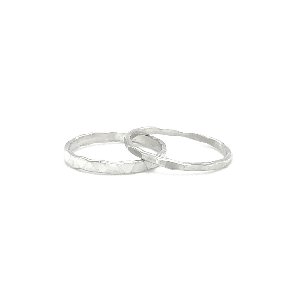 
                  
                    A white background showcases two Diamond Cut Minimalist Silver Bands, perfect for men.
                  
                