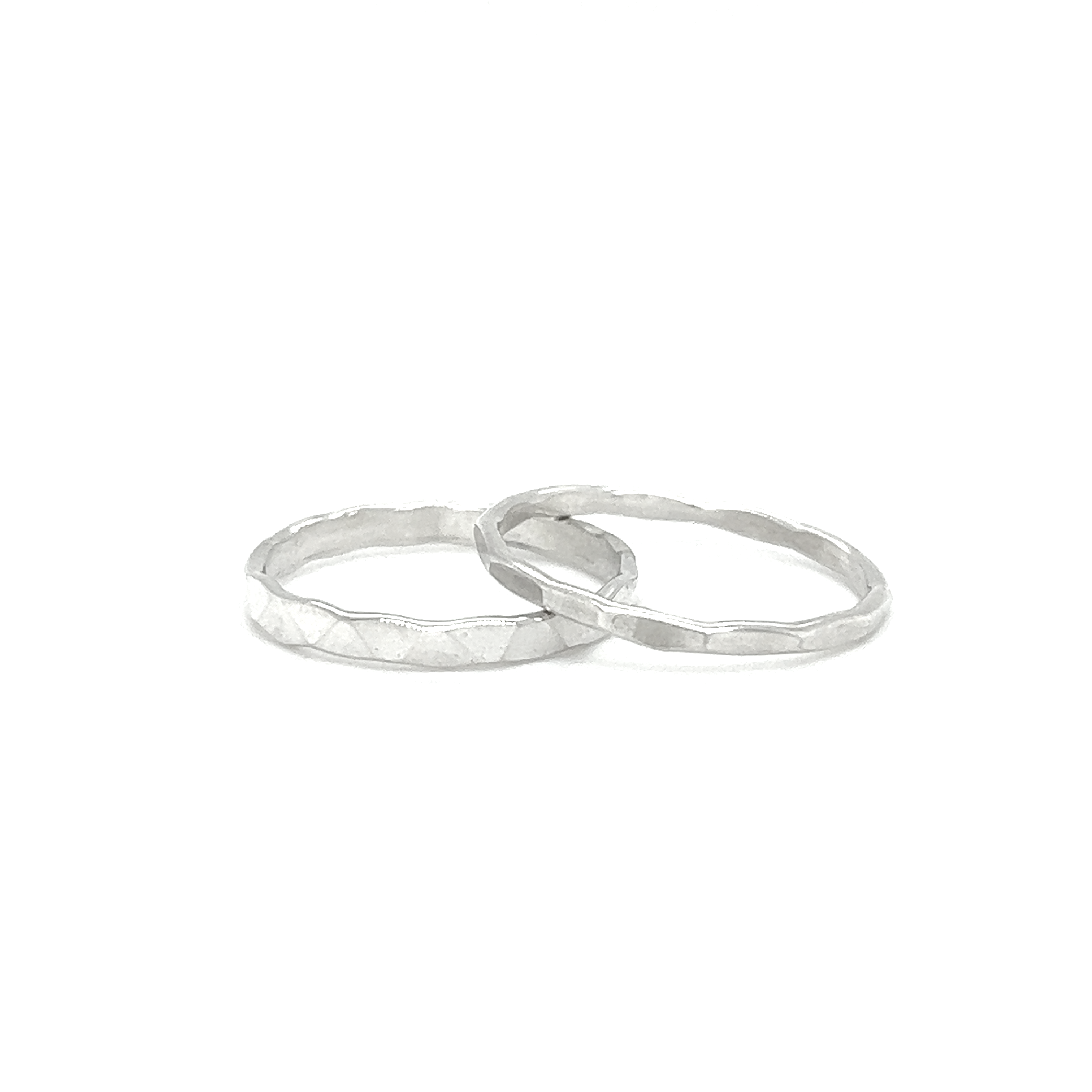 A white background showcases two Diamond Cut Minimalist Silver Bands, perfect for men.