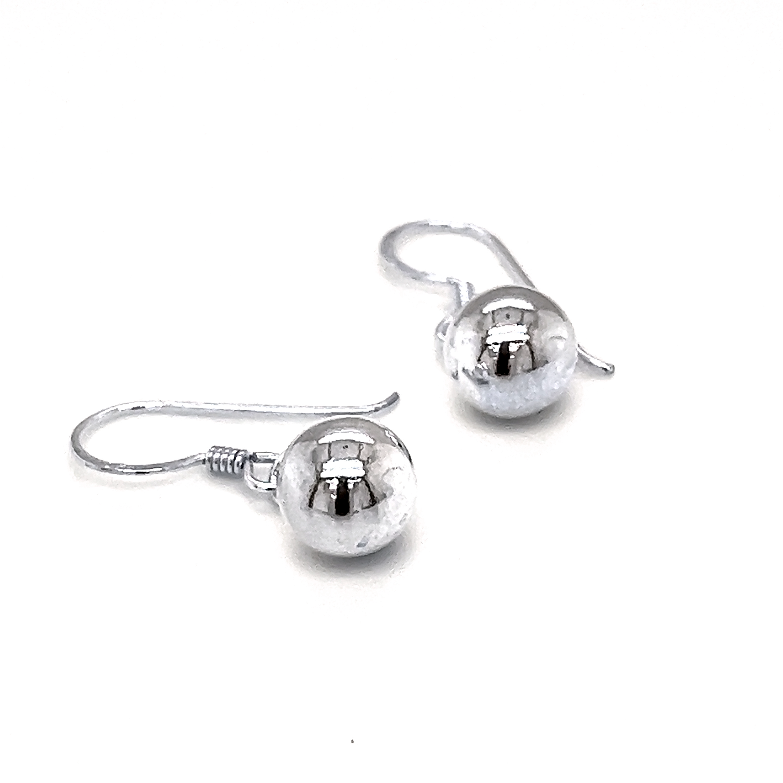 A pair of Simple Dangling Ball Earrings from Super Silver with understated glamour on a white background.