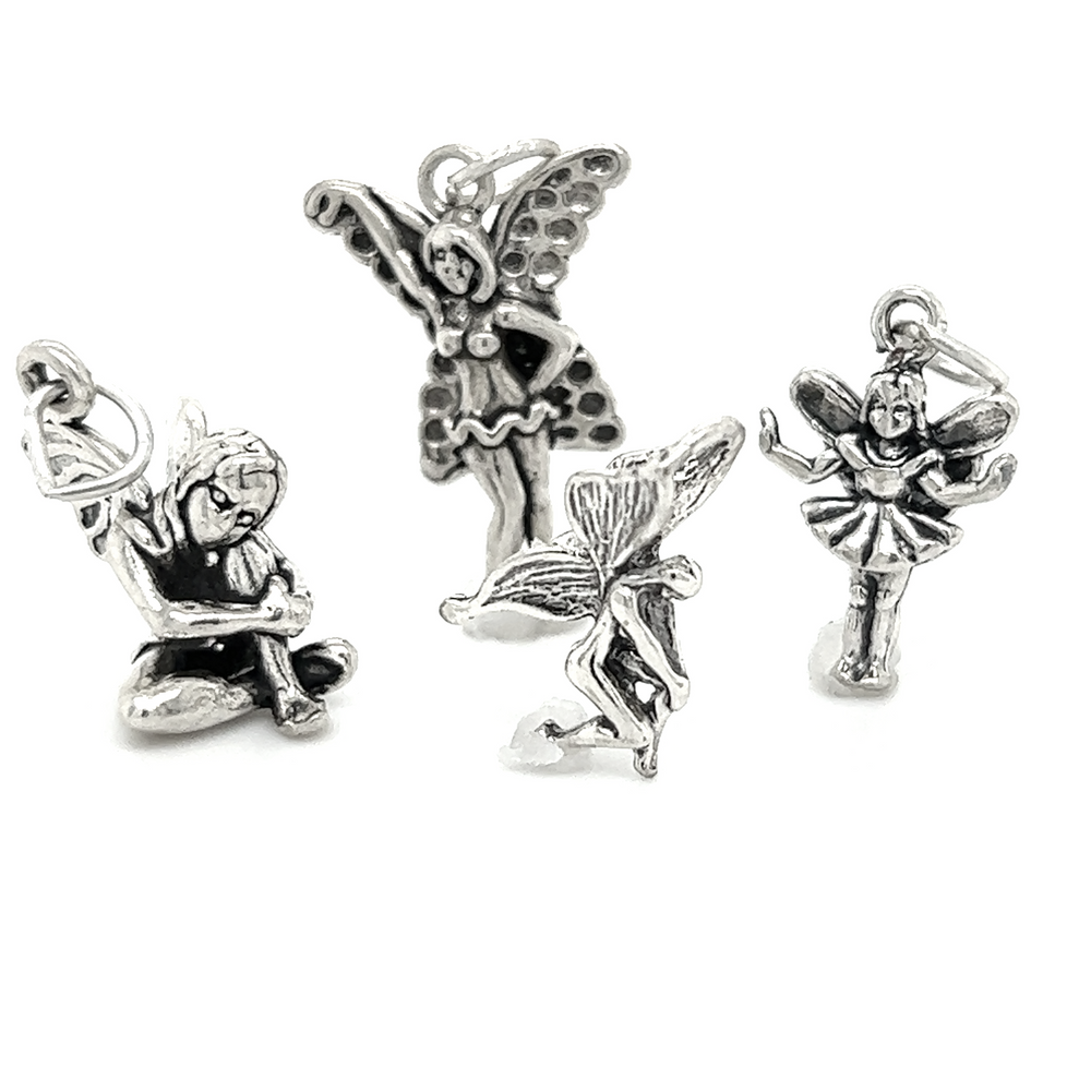 Four Super Silver fairy charms with enchanting magic on a white background.