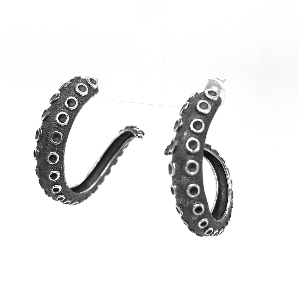
                  
                    A pair of Super Silver Edgy Octopus Tentacle Hoop Earrings showcasing oceanic charm on a white background.
                  
                