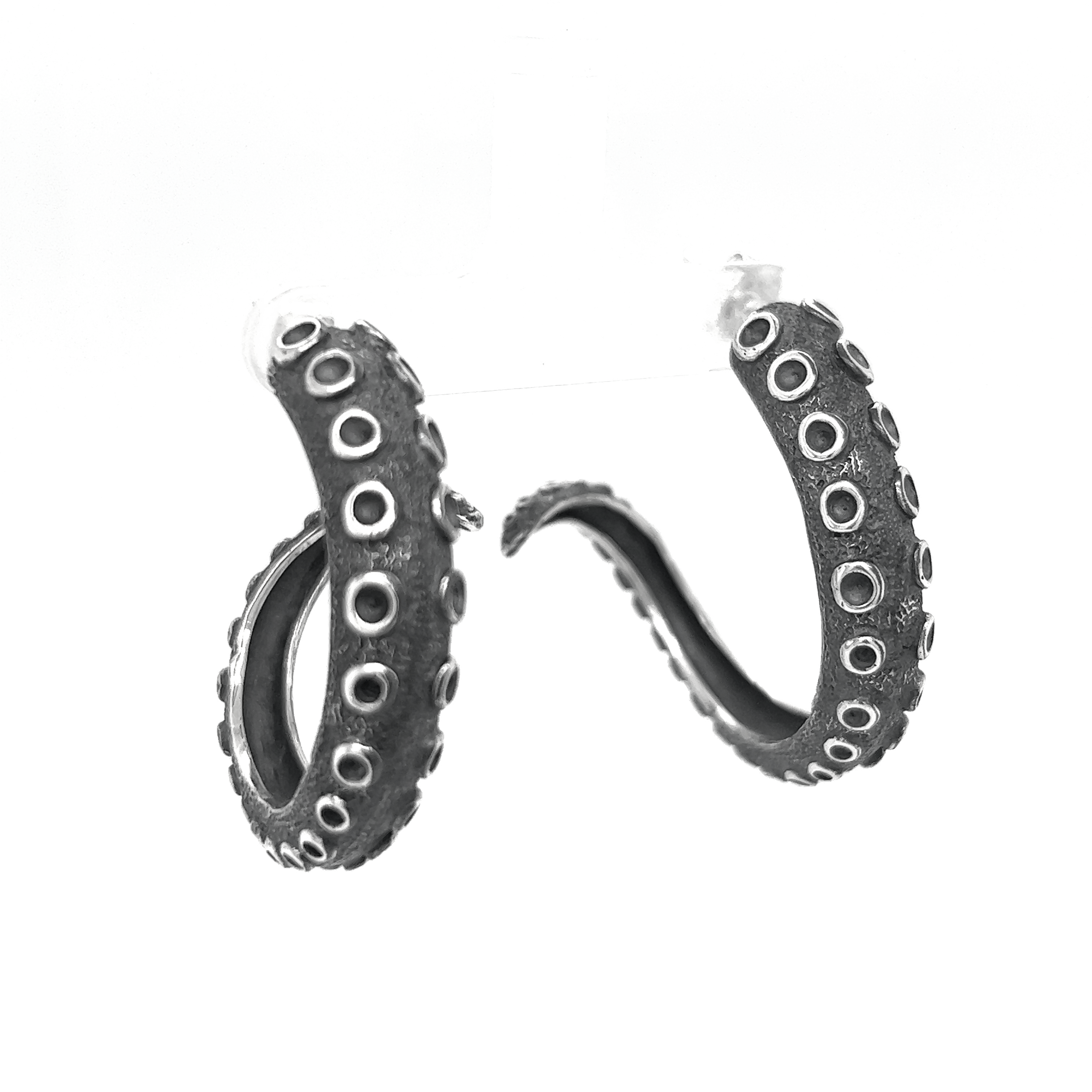 A pair of Super Silver Edgy Octopus Tentacle Hoop Earrings on a white background, exuding oceanic charm.