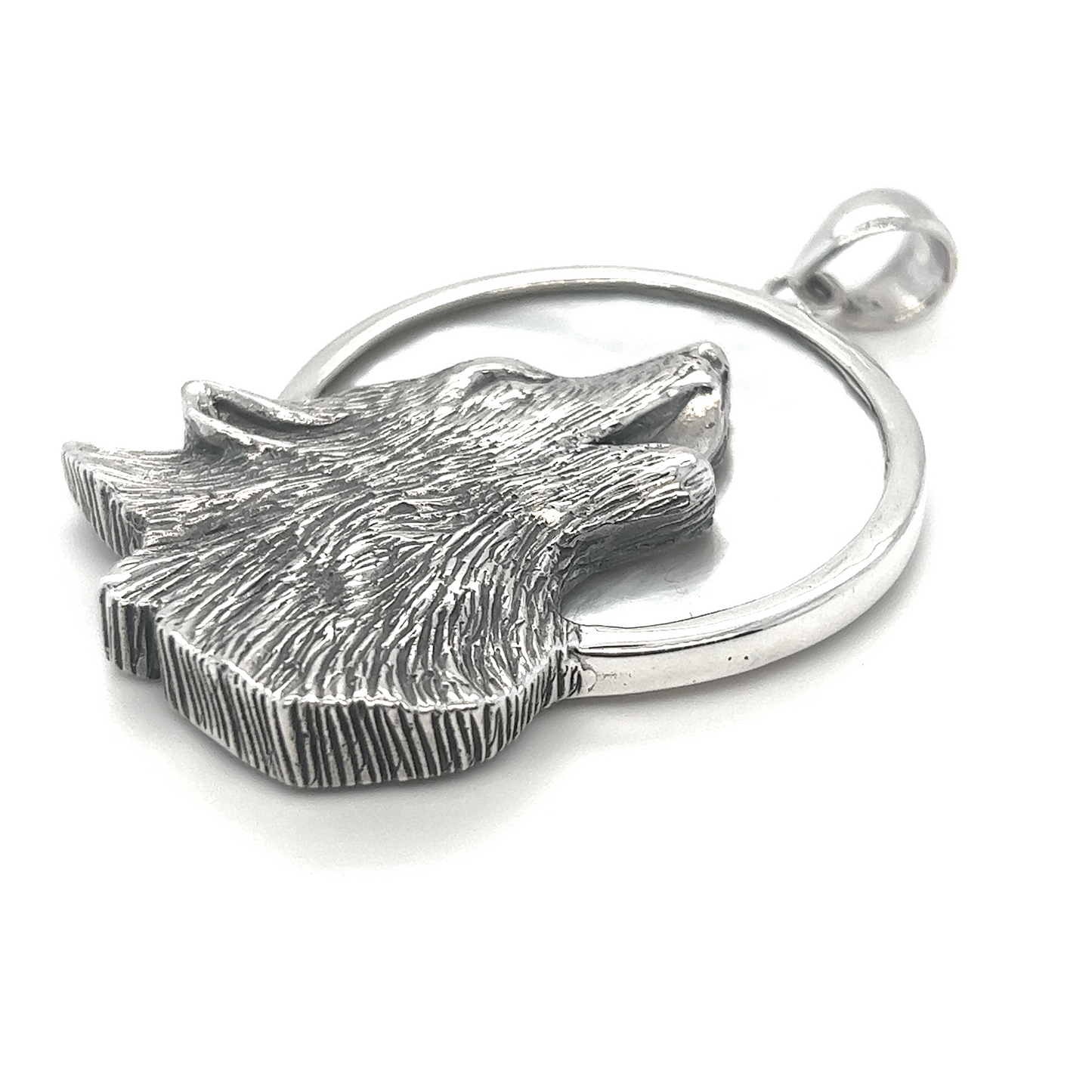 A symbolic Wolf Howling At The Full Moon Pendant with a wolf head on it from Super Silver.
