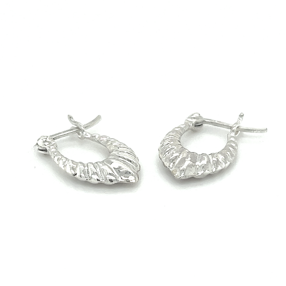 
                  
                    A pair of Super Silver Dainty Latch Hoop Earrings on a minimalist white background.
                  
                
