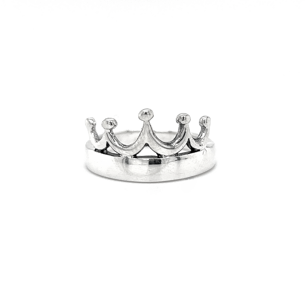 The Sleek Crown Ring, crafted from sterling silver and shaped like a crown, exudes regal allure as it rests elegantly on a plain white background.