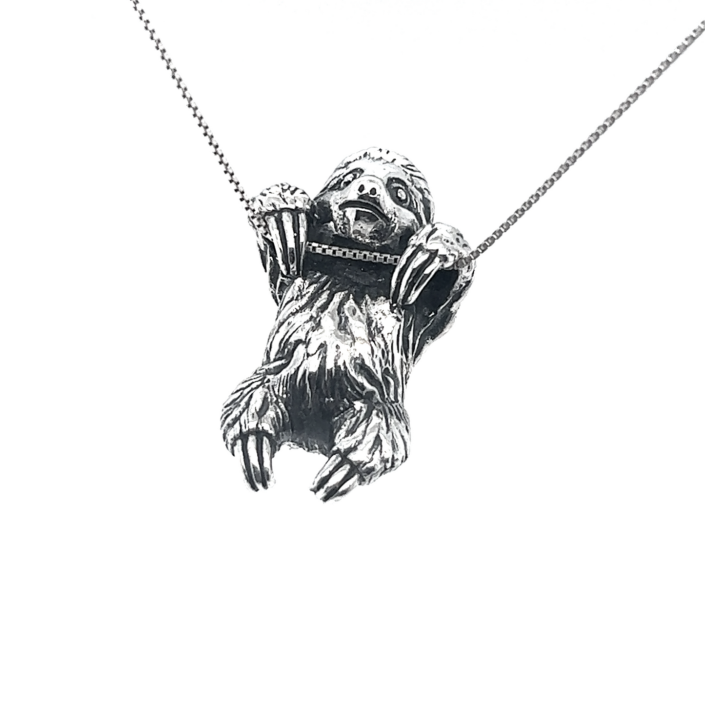 
                  
                    An intricately crafted Super Silver sloth pendant, part of an artisan collection, delicately hangs from a chain on this necklace.
                  
                
