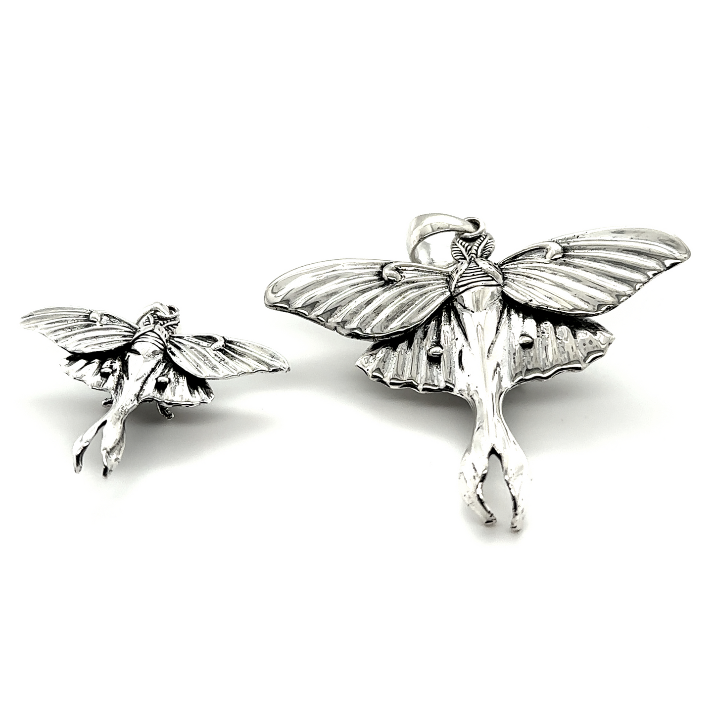 Two Statement Lunar Moth Pendants by Super Silver with wings that symbolize transformation.