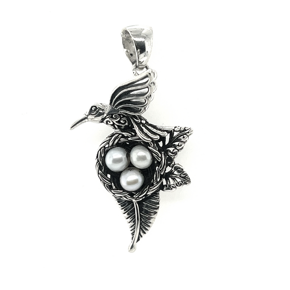 A Super Silver Hummingbird Pendant with Nest of Pearls, making it a beautiful piece of jewelry.