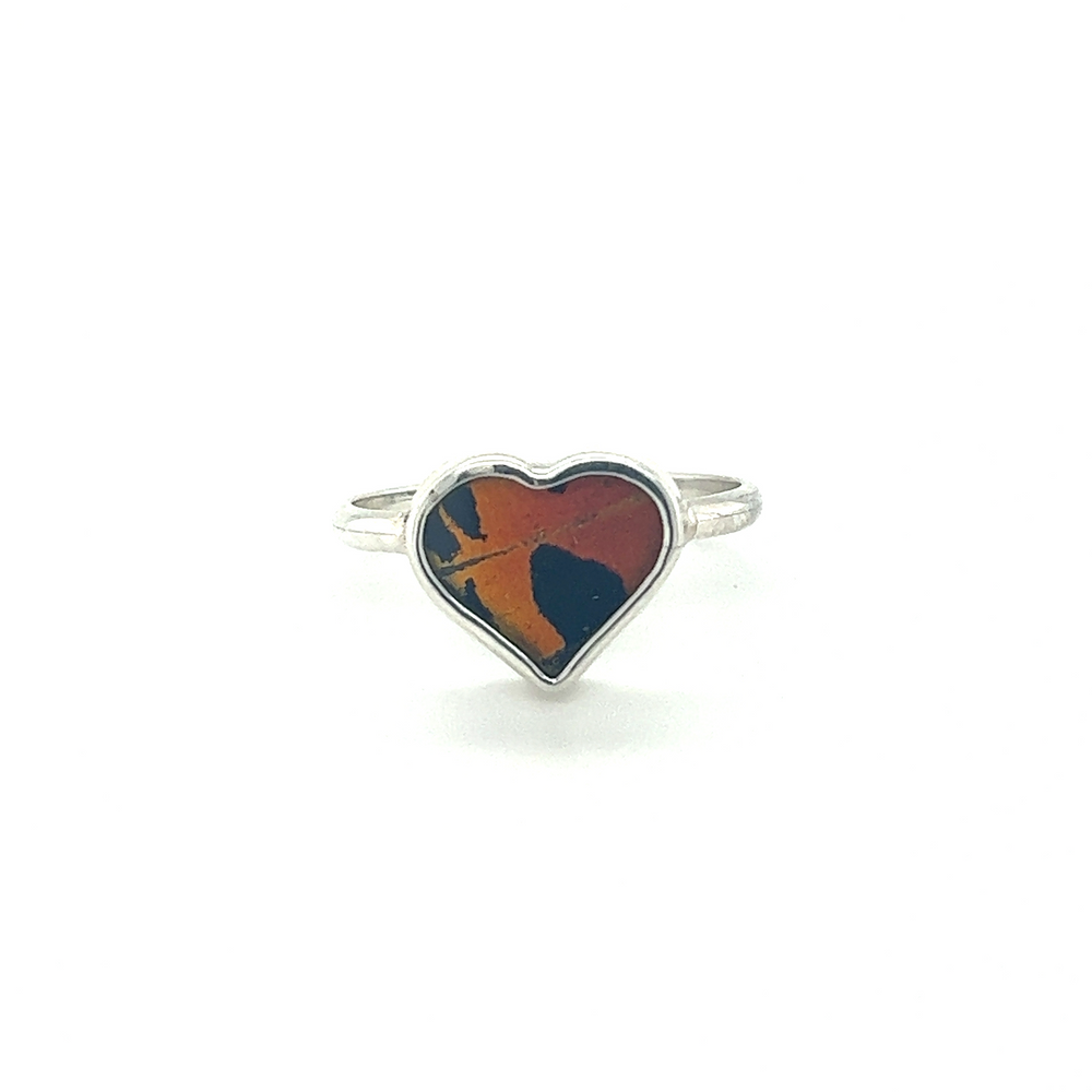 
                  
                    A statement Genuine Butterfly Heart-shaped ring in sterling silver with an orange and blue heart.
                  
                