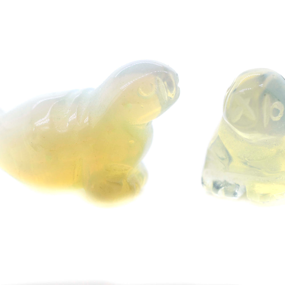 
                  
                    A pair of Carved Opalite Seal Figures on a white background.
                  
                