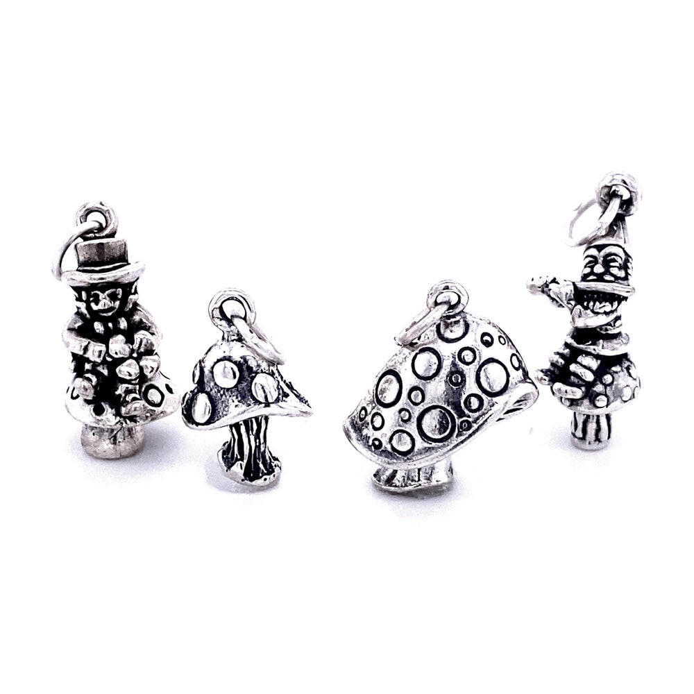 Four silver charms are displayed: a snowman, a mushroom, a polka dot mushroom, and a clown. These Mystical Mushroom Charms capture whimsical delight with their intricate designs.