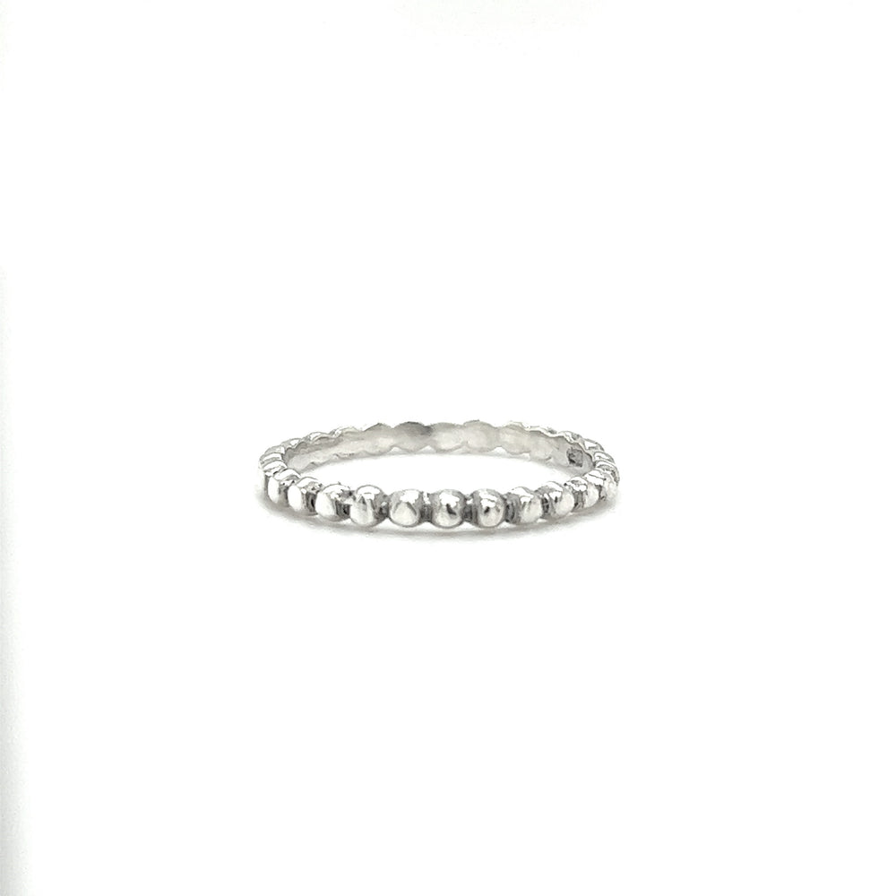 A trendy stacker, the delicate charm of this Tiny Beaded Ring shines against a pristine white background.