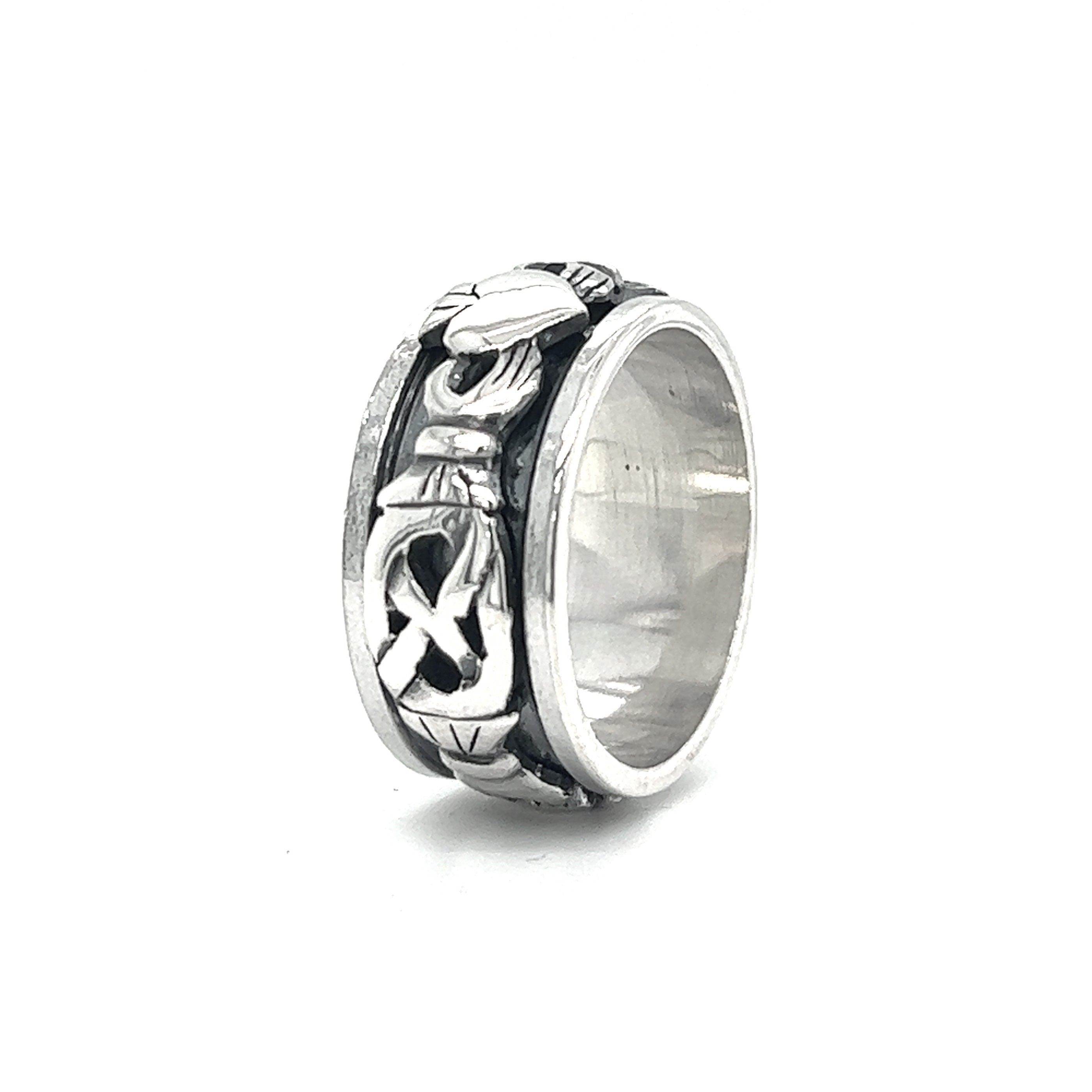A Bold Claddagh Spin Ring with a Celtic design and a spinner feature.