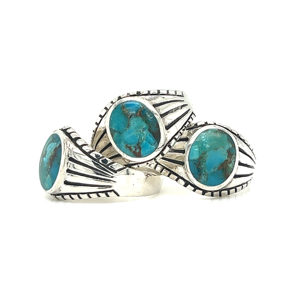
                  
                    Three statement silver Oval Signet Stone rings with turquoise stones.
                  
                