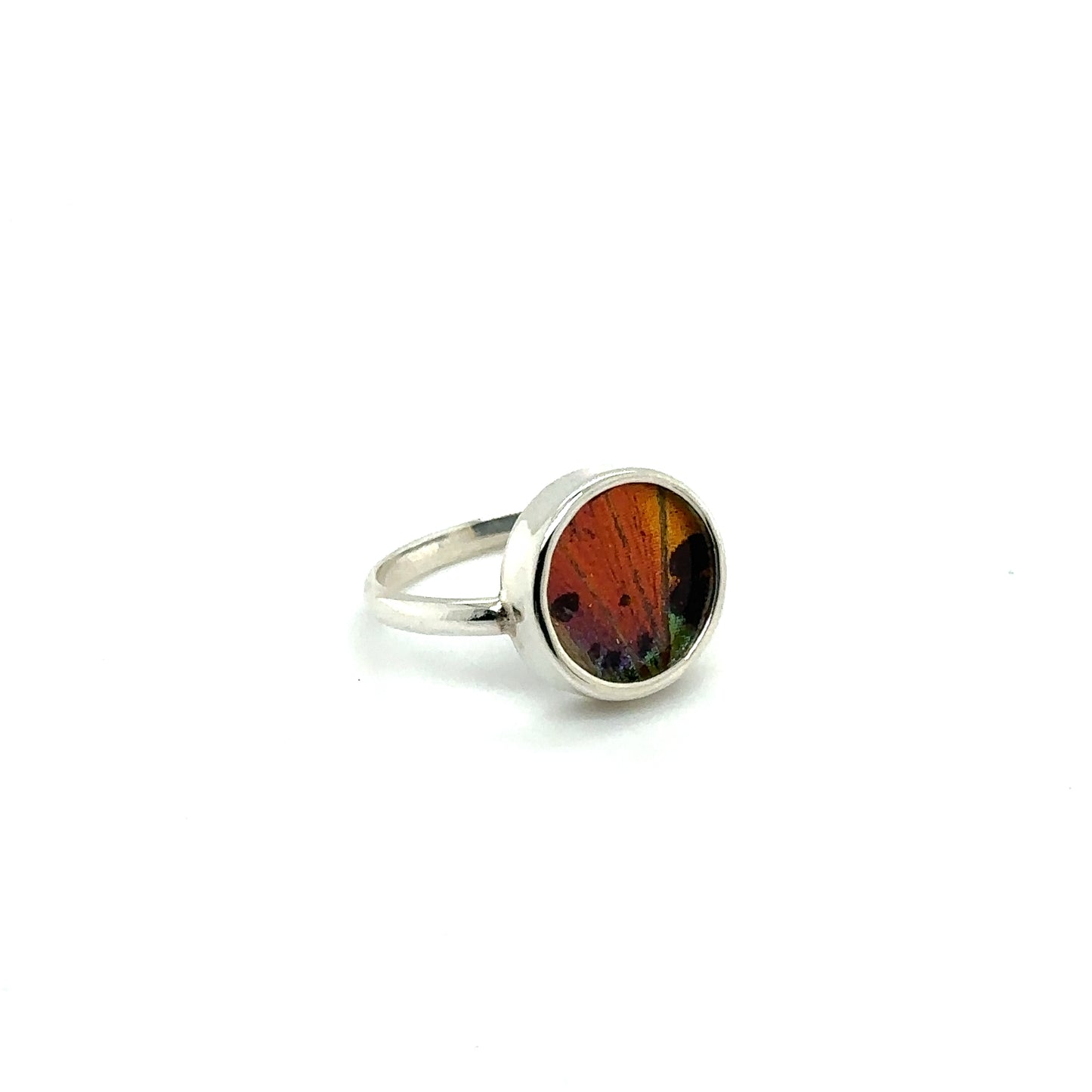 
                  
                    A Butterfly Wing Ring in Circle Shape in silver with a red and orange band.
                  
                