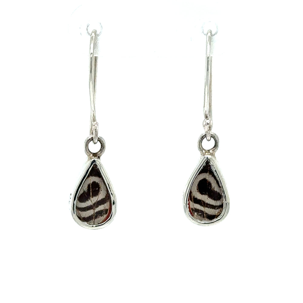 A statement pair of Small Butterfly Wing Earrings with a black and white pattern.