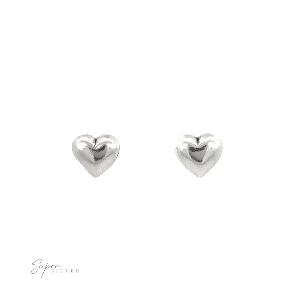 A pair of Simple Heart Studs, symbolizing love, on a white background.