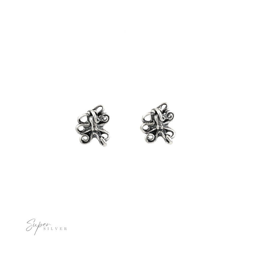 
                  
                    A pair of silver Intricate Octopus Studs featuring intricate octopus designs on a white background.
                  
                