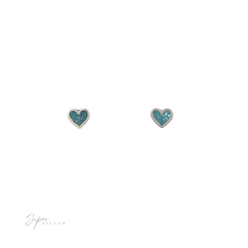 A pair of Tiny Turquoise Heart Studs on a white background.