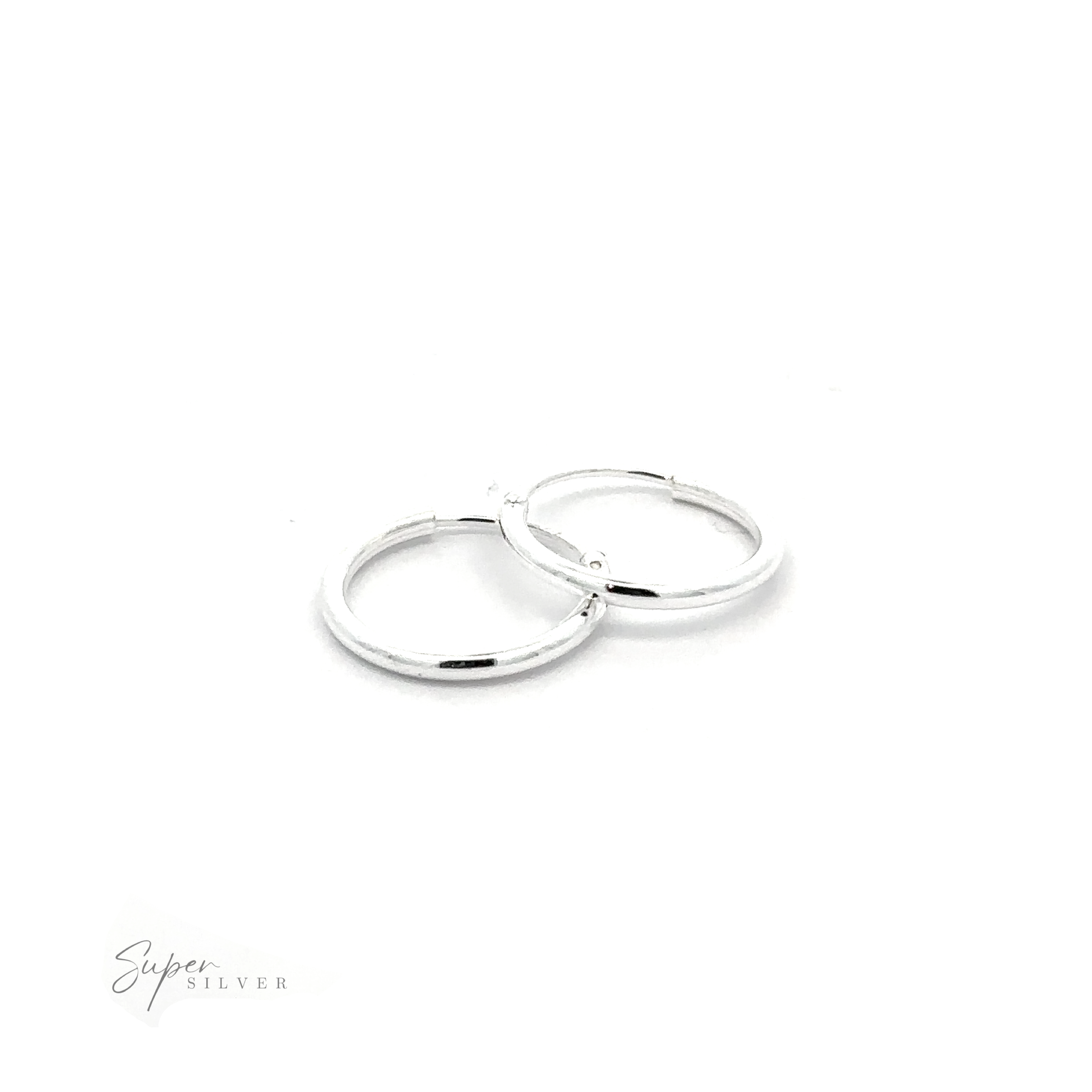 A pair of 1.2mm Infinity Hoops gleam against a white background, with ".925 Sterling Silver" text shimmering in the corner.
