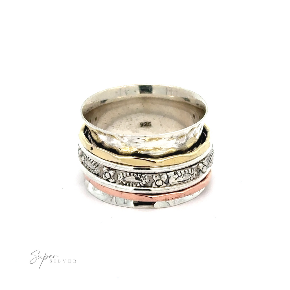 
                  
                    A stack of Tricolor Handmade Spinner Rings with a Flower Pattern Band on a white background.
                  
                