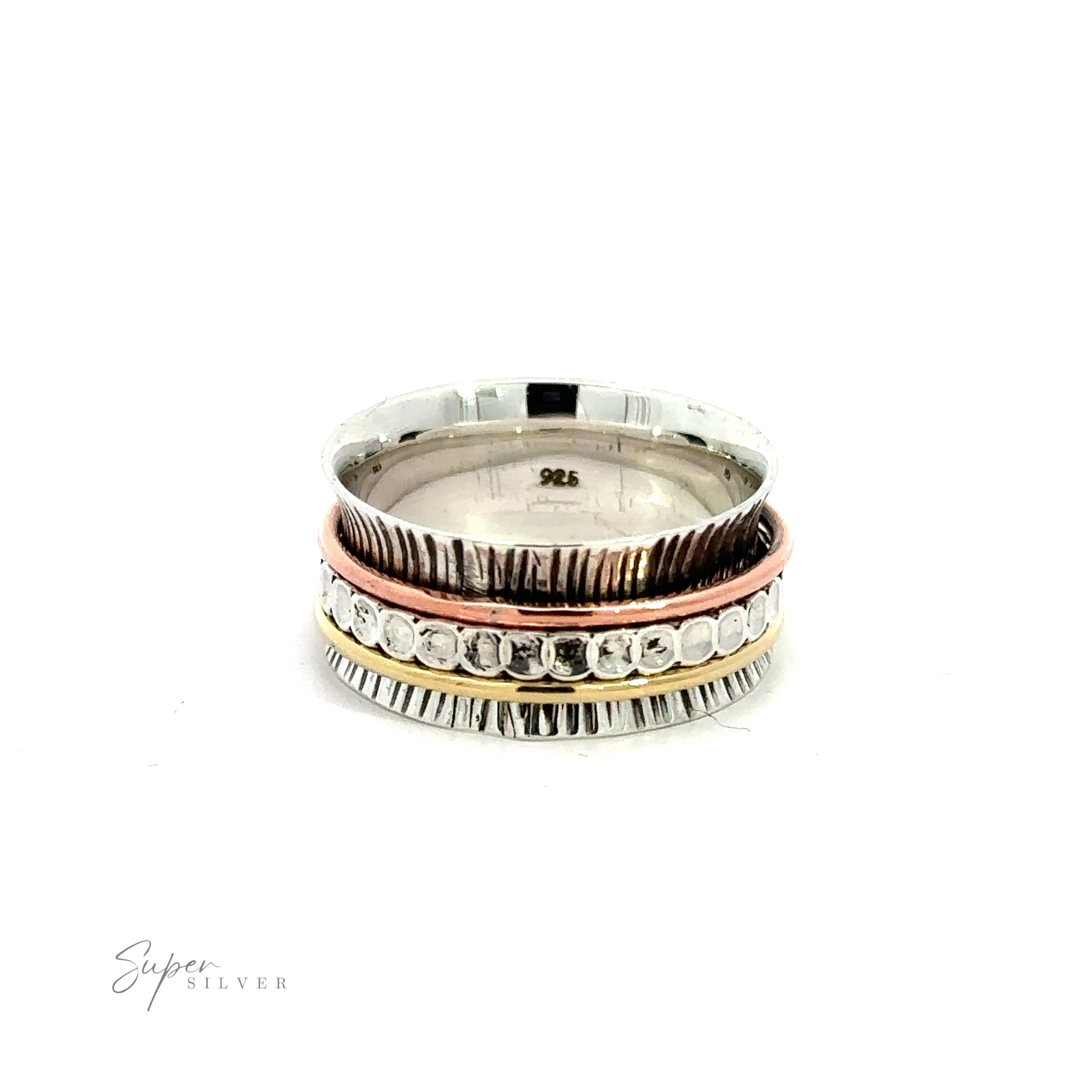 A stack of Handmade Tricolor Etched Spinner Rings, featuring both silver and gold rings, on a white background.