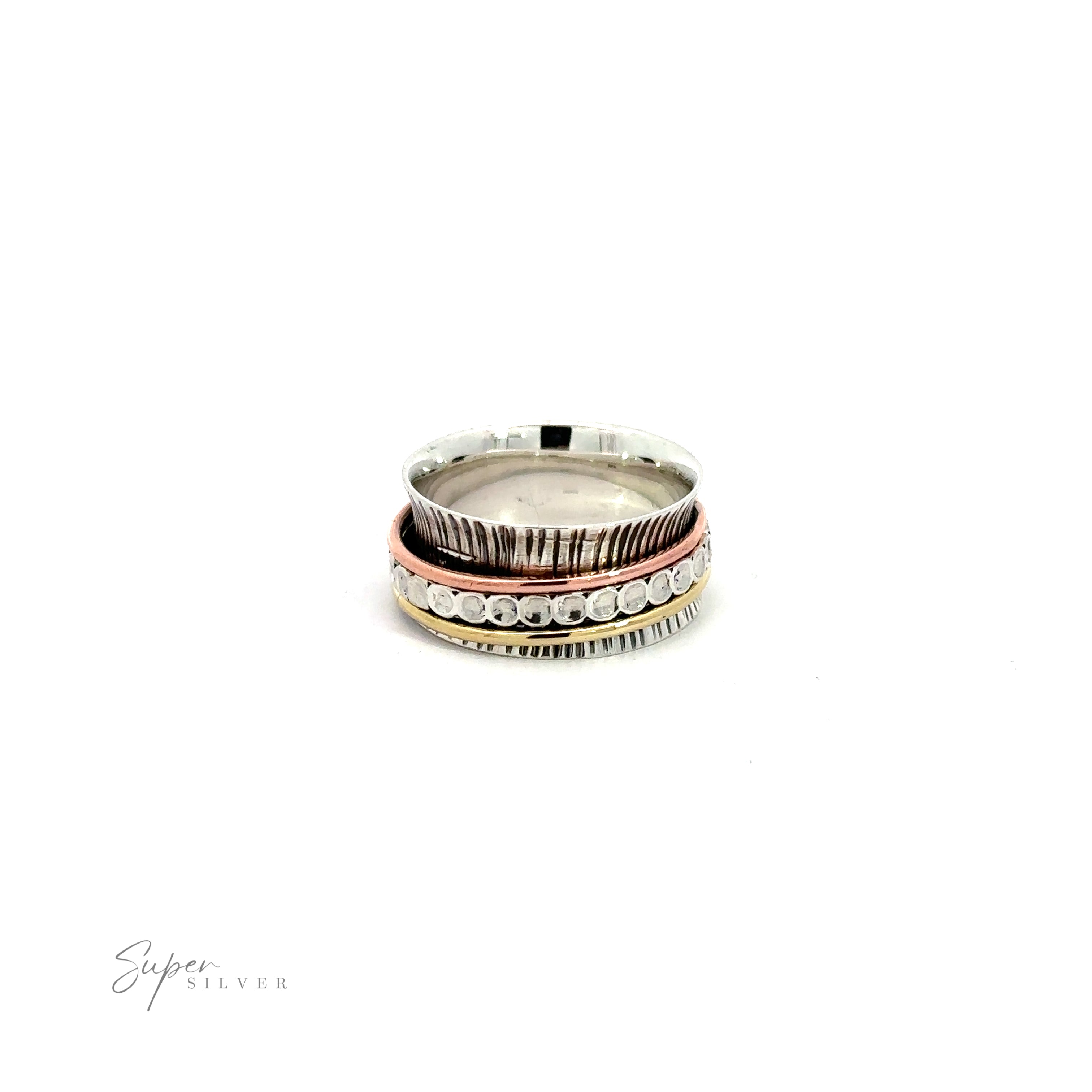 A stack of three Handmade Tricolor Etched Spinner Rings on a white background.