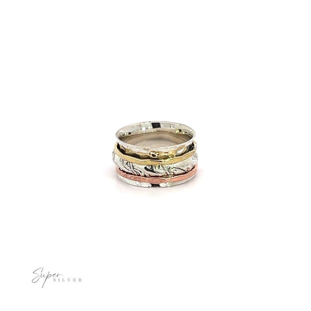 
                  
                    A stack of Handmade Spinner Rings with a Filigree Pattern Band, featuring a delicate filigree pattern and a hammered tricolor ring, set against a pristine white background.
                  
                