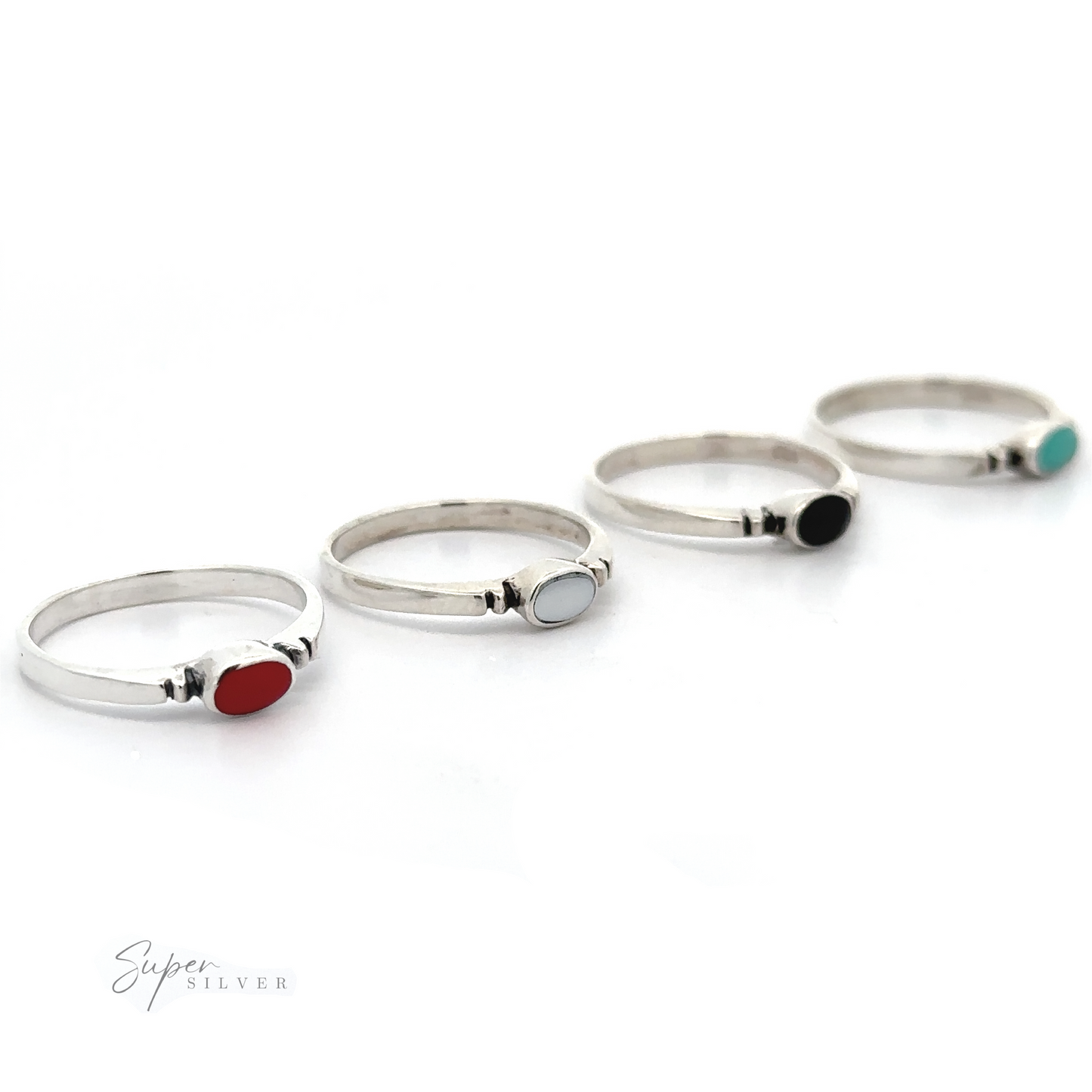 Four Small Horizontal Oval Inlay Rings with different colored stones featuring notched details on a white background.