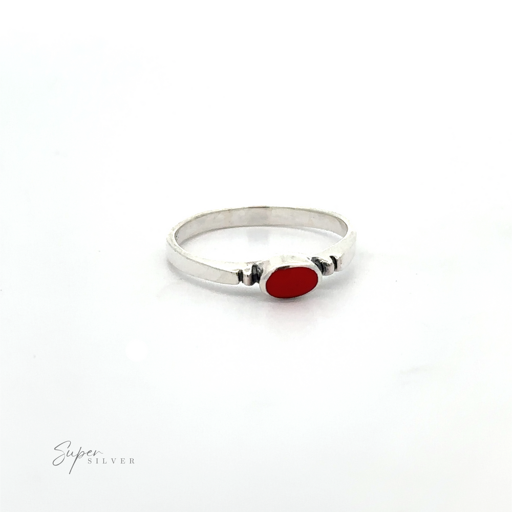 
                  
                    A dainty and sleek Small Horizontal Oval Inlay Ring with a minimalist style and a sideways oval red stone on it.
                  
                