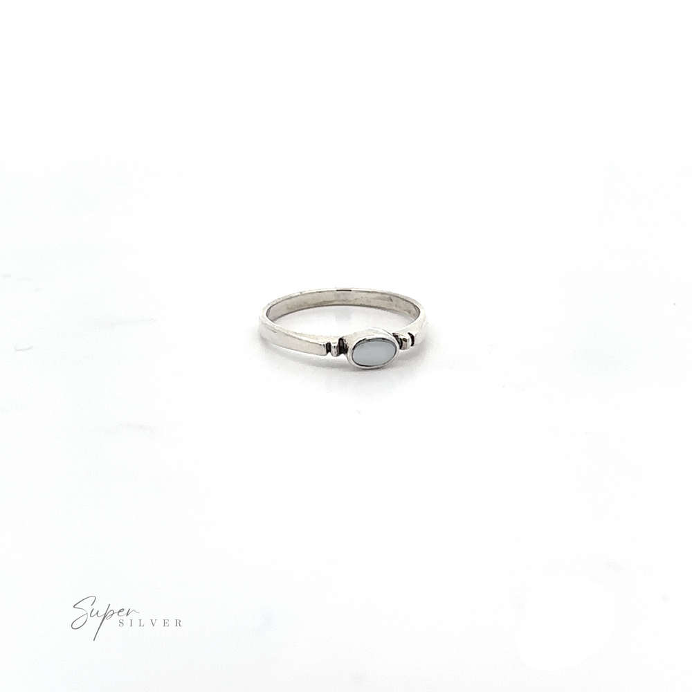
                  
                    A dainty and sleek Small Horizontal Oval Inlay Ring on a minimalist style background.
                  
                