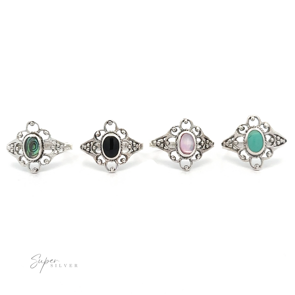 
                  
                    A set of four Vintage-Styled Flower Rings with Inlaid Stones, combining vintage appeal and lacey petals.
                  
                
