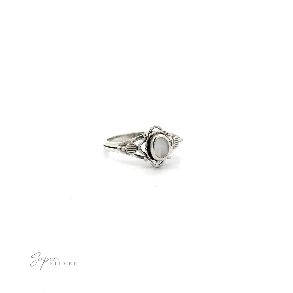 
                  
                    A Fancy Oval Inlay Stone Ring with a white stone in the middle, featuring a vintage flower motif.
                  
                