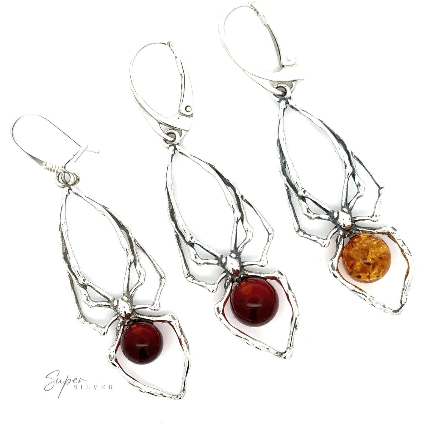 Three pairs of Beautiful Amber Spider Earrings with Baltic amber and red gemstone accents, symbolizing self-empowerment.