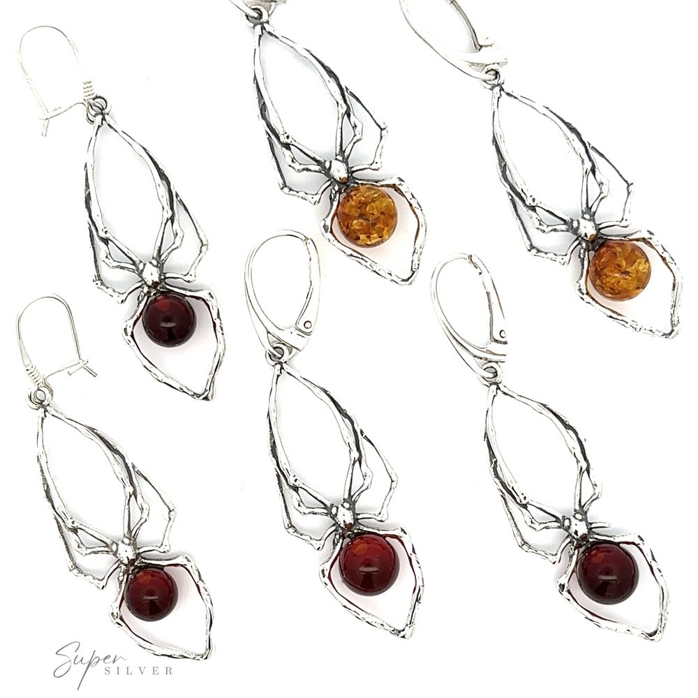An array of silver Beautiful Amber Spider Earrings on a white background.