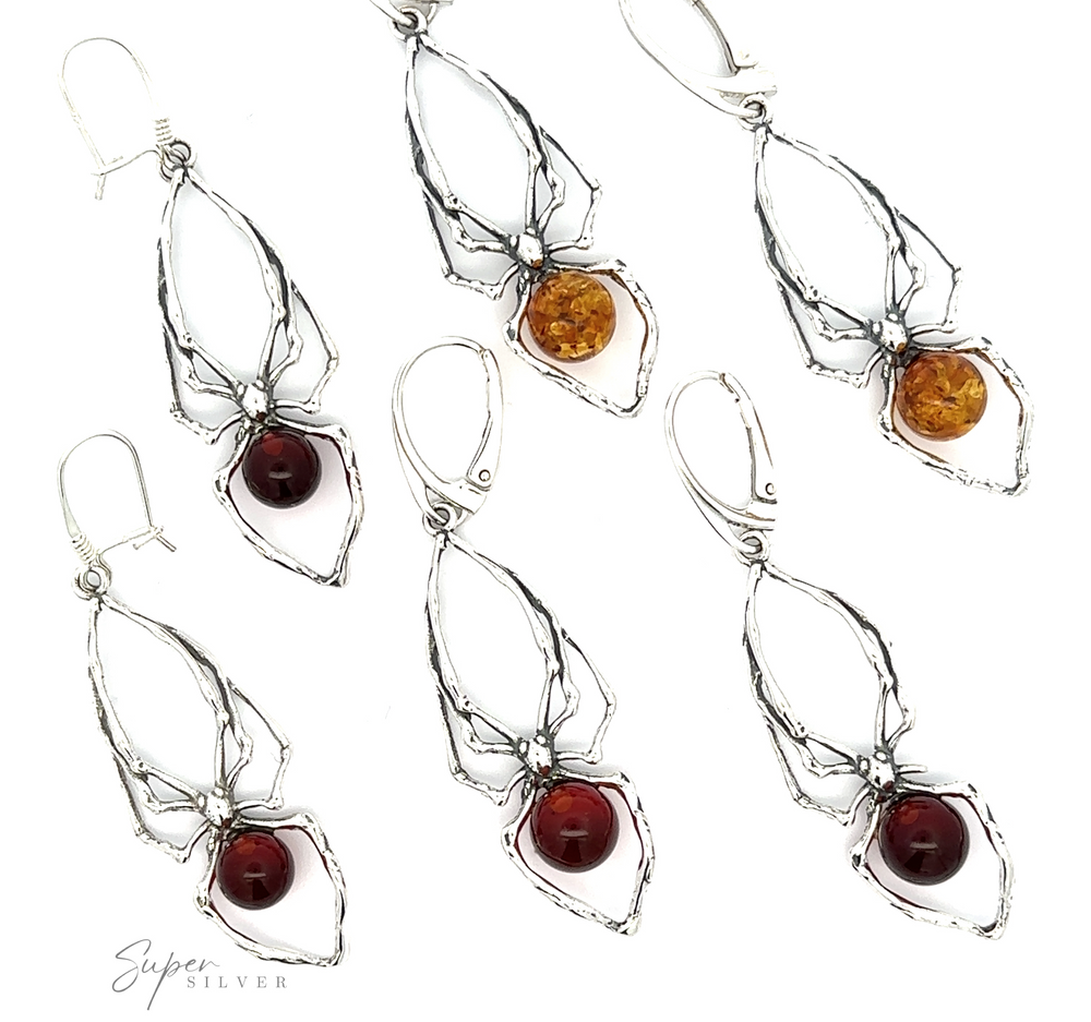 An array of silver Beautiful Amber Spider Earrings on a white background.