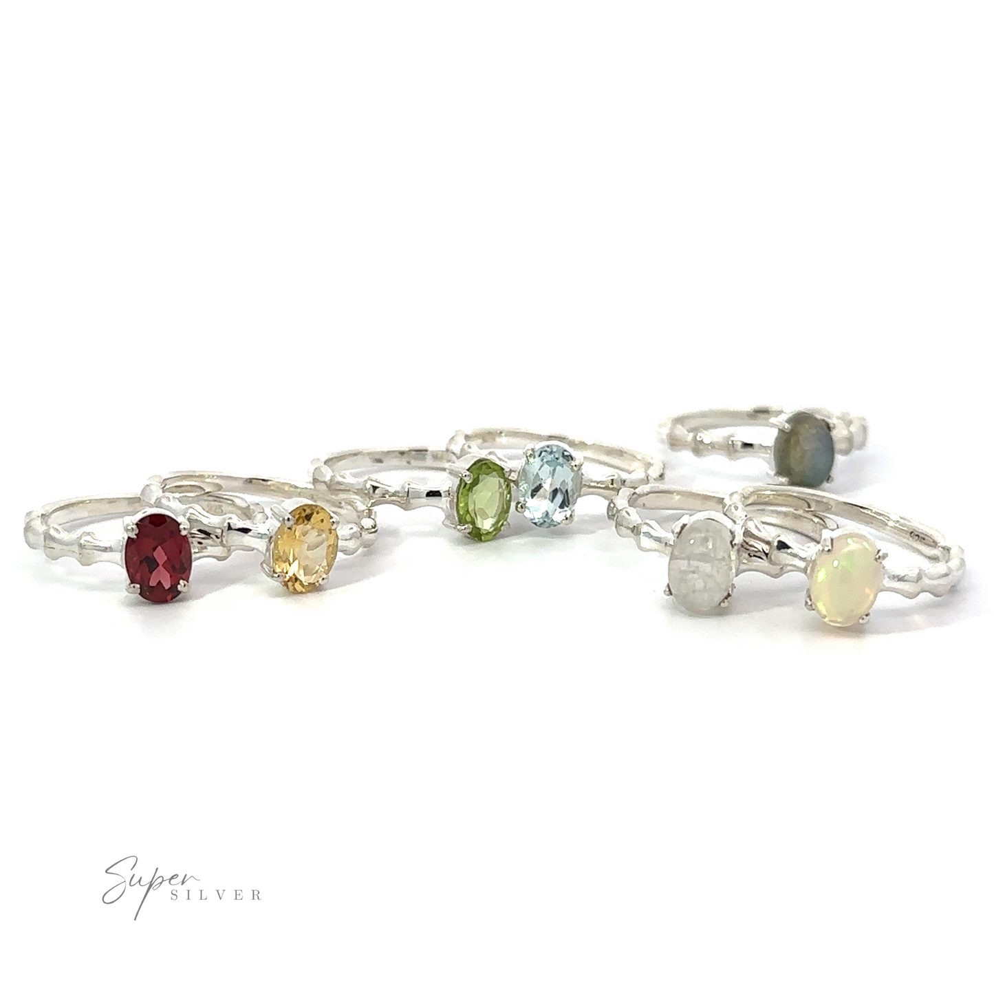 
                  
                    A collection of Pronged Oval Gemstone Rings with Textured Bands in .925 Sterling Silver displayed on a white background.
                  
                