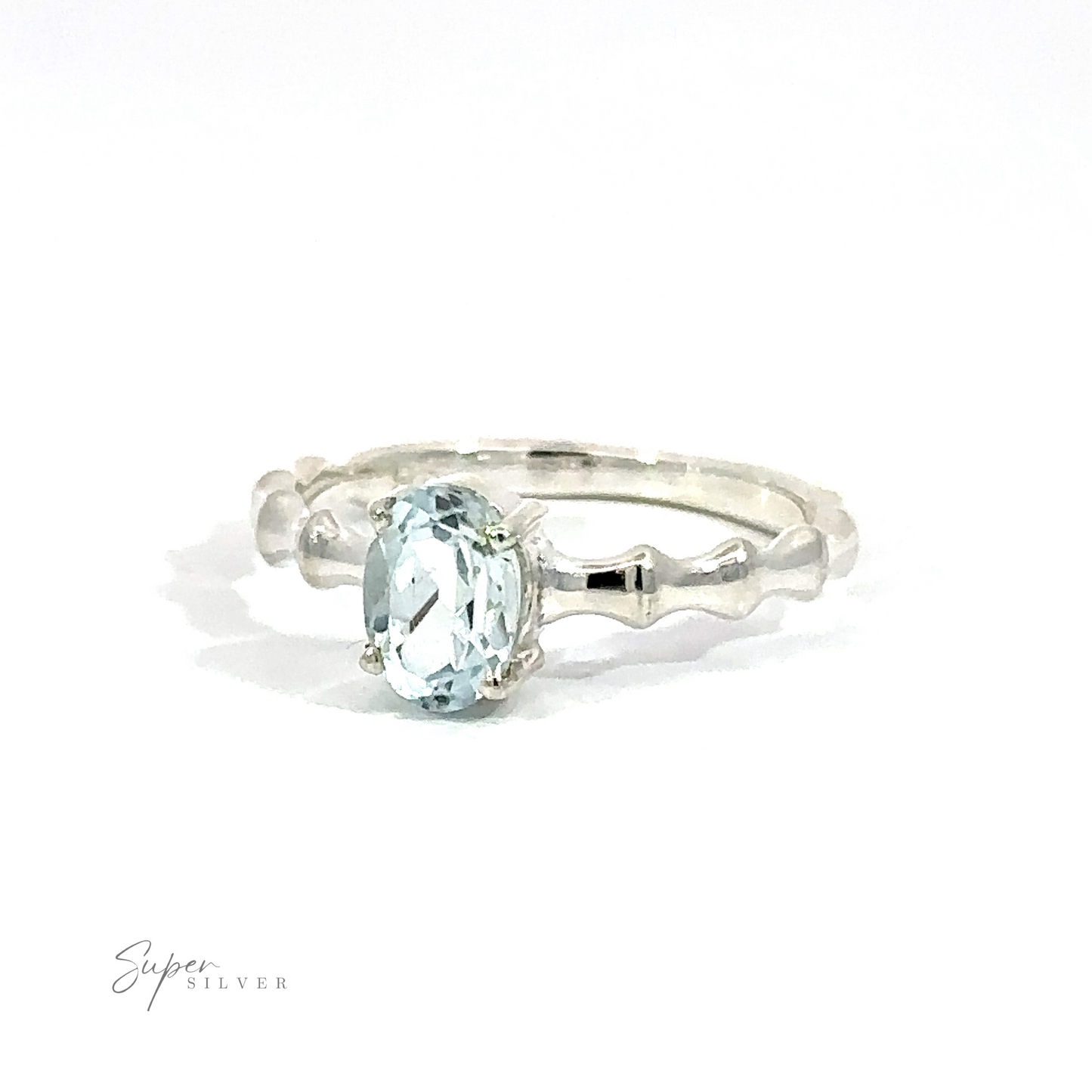 
                  
                    Pronged Oval Aquamarine Ring with Textured Band on a white background.
                  
                