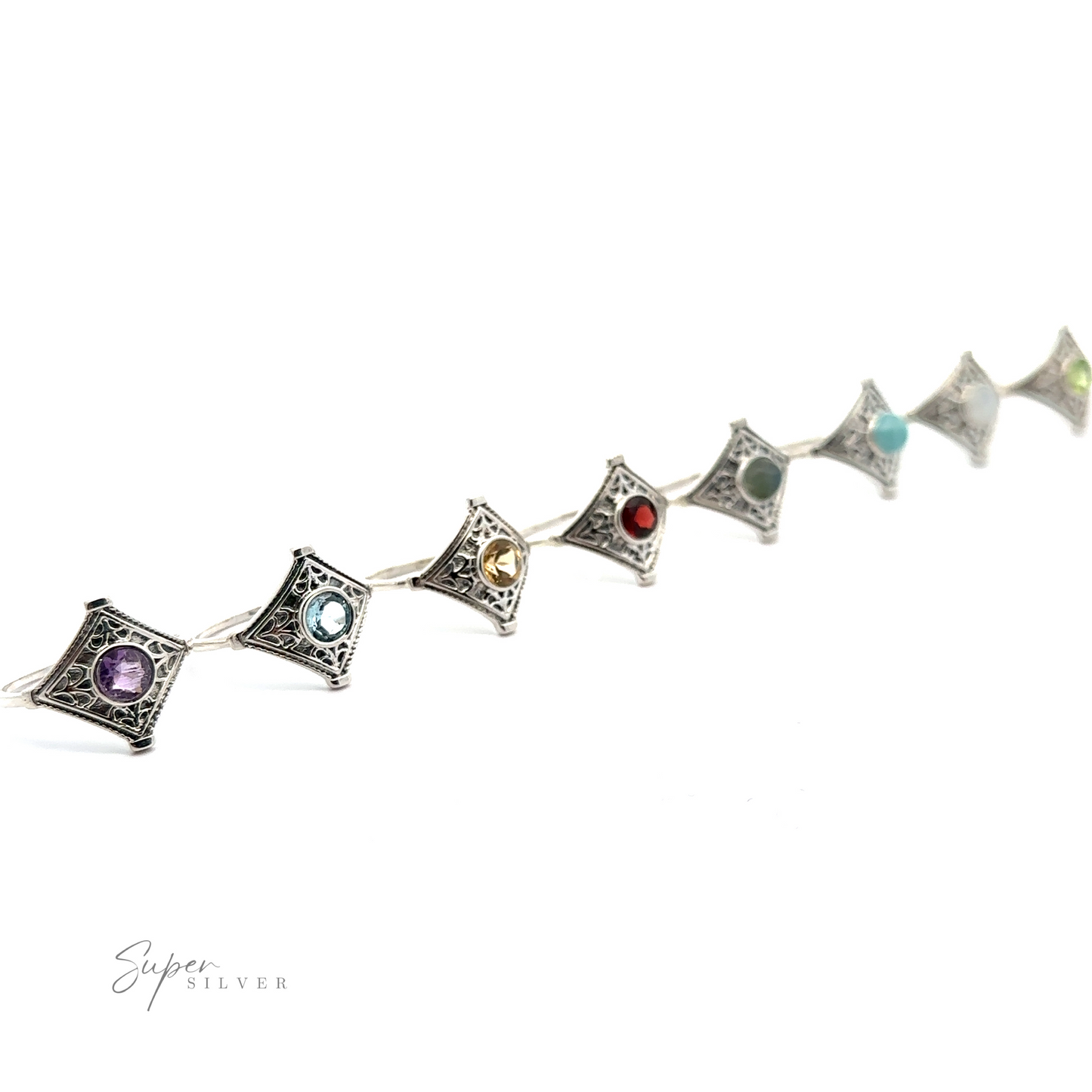 
                  
                    A line of six Intricate Diamond Silver Rings with a Round Gemstone, against a white background.
                  
                