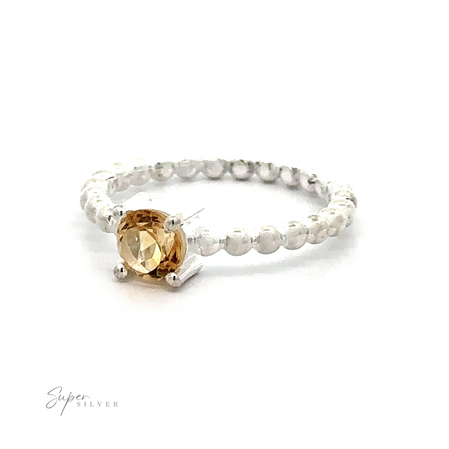 
                  
                    A Stunning Circular Gemstone Ring with Beaded Band with a central amber-colored gemstone on a white background.
                  
                