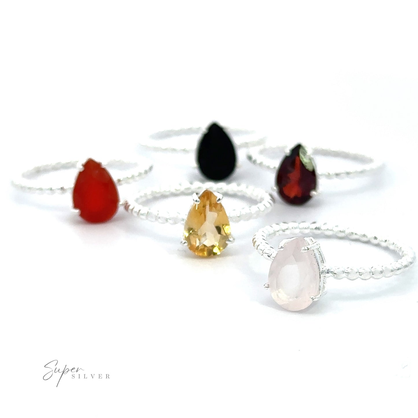 
                  
                    An assortment of Vibrant Teardrop Gemstone Rings with Beaded Bands on a white background.
                  
                