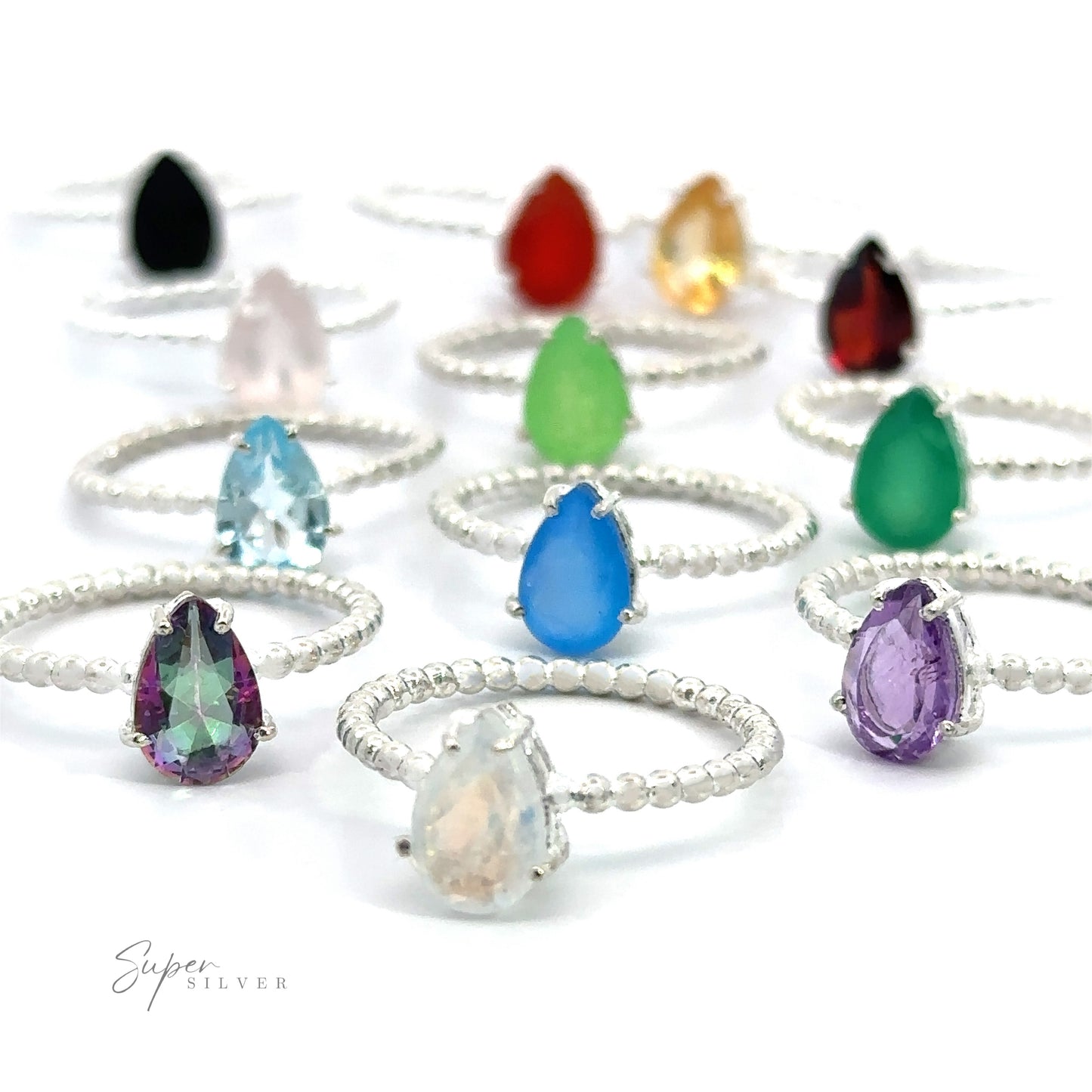 
                  
                    A collection of Vibrant Teardrop Gemstone Rings with Beaded Bands on a white background.
                  
                