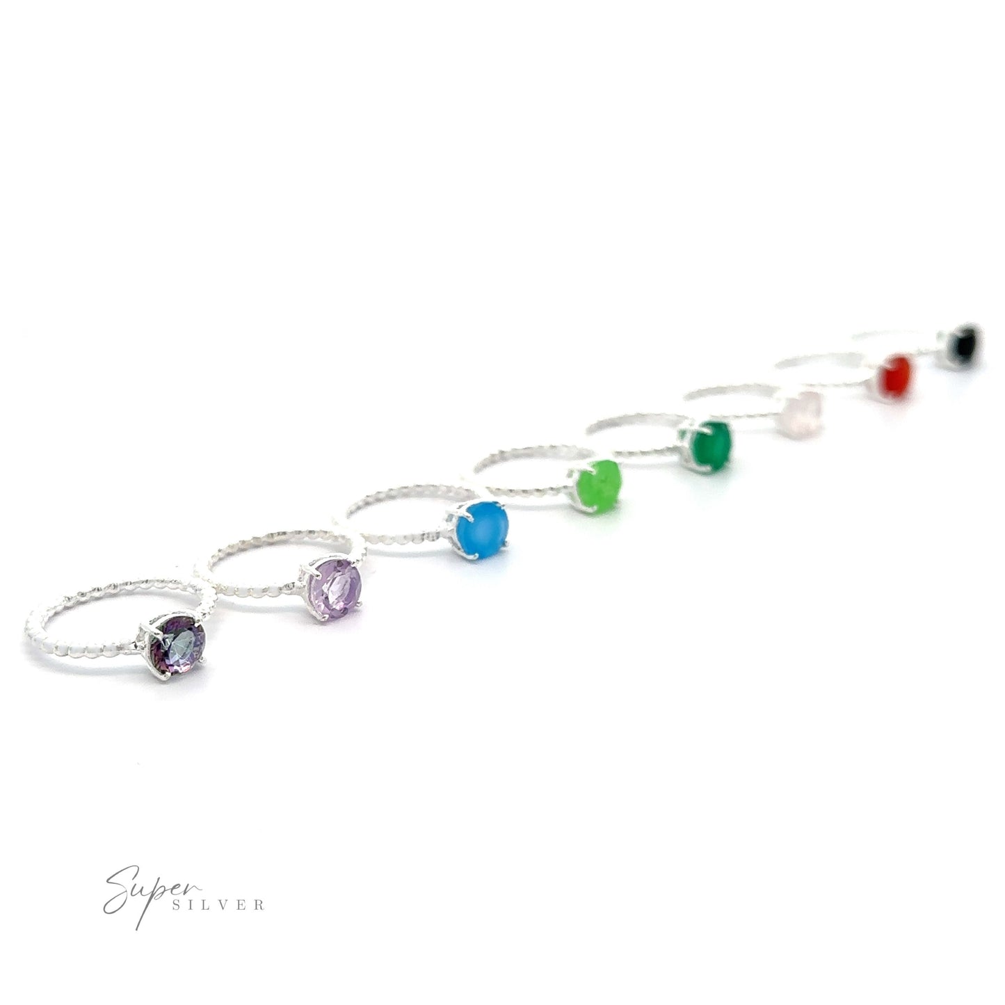 A collection of Stunning Circular Gemstone Rings with Beaded Bands in small sizes displayed in a diagonal line on a white background.