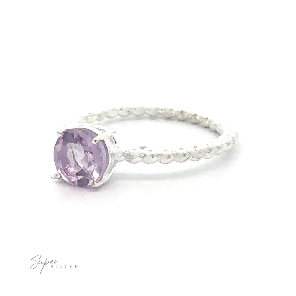 
                  
                    Stunning Circular Gemstone Ring with Beaded Band Small Sizes with a vibrant purple gemstone on a white background.
                  
                