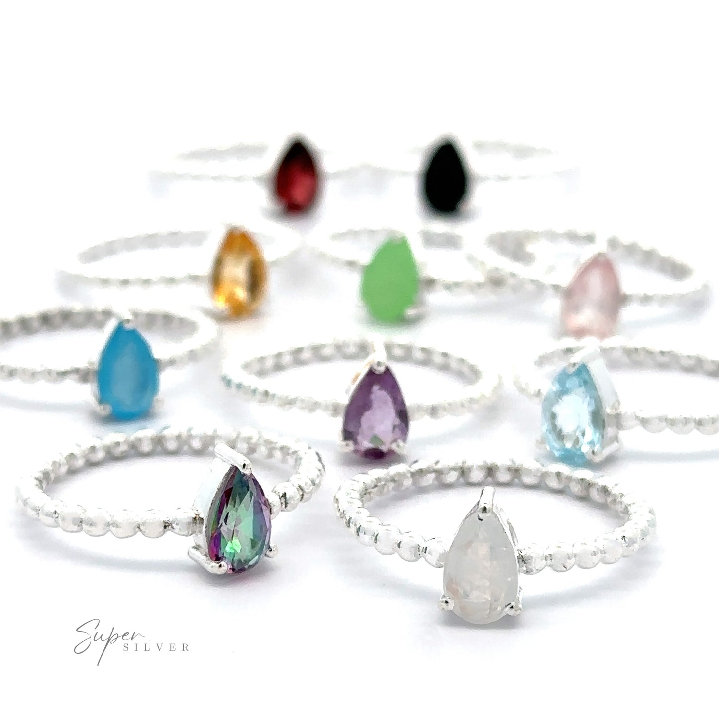 A collection of Sparkling Teardrop Gemstone on Beaded Band rings with various colored teardrop gemstones in a prong setting on a white background.