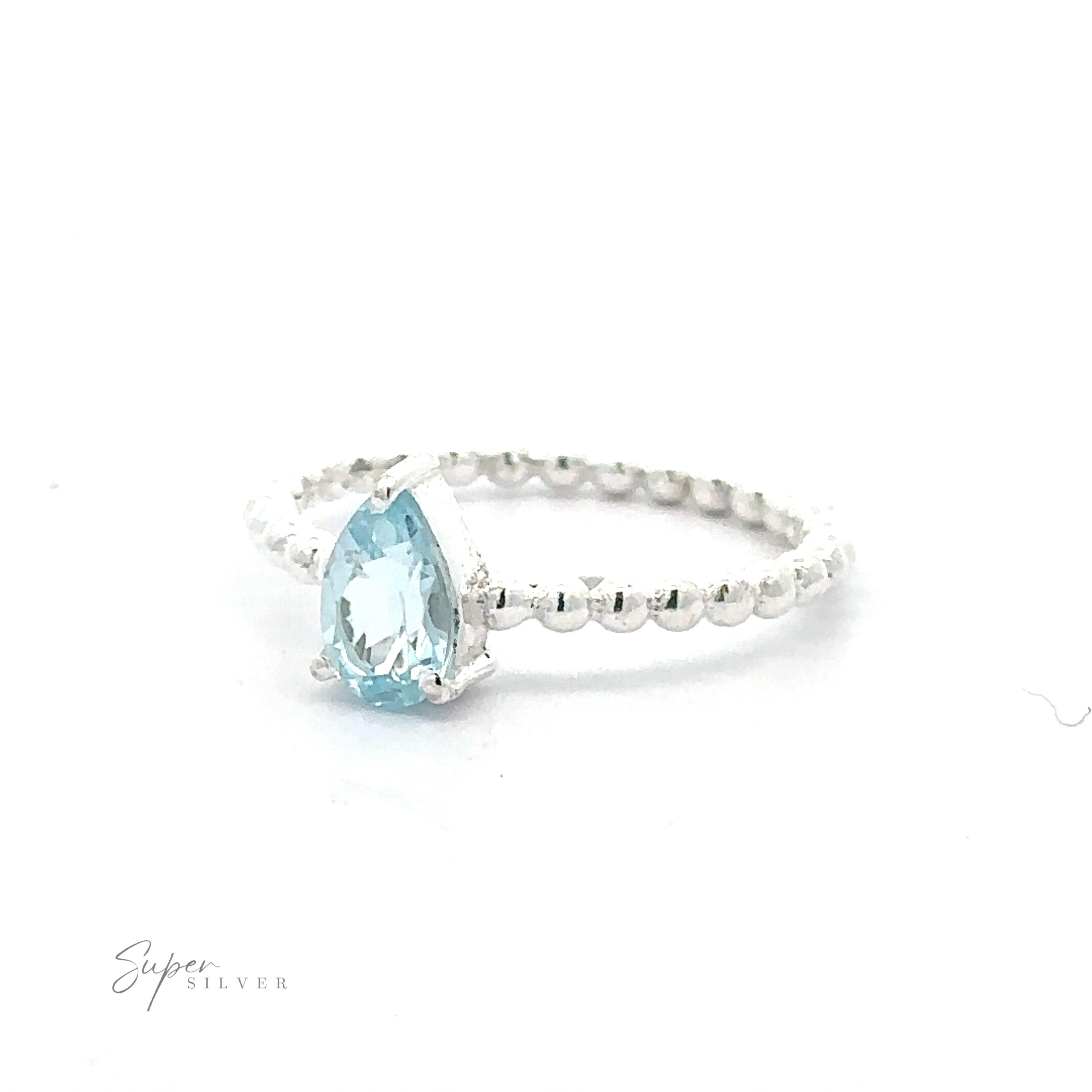 Sparkling Teardrop Gemstone on Beaded Band with a pear-shaped light blue gemstone in a prong setting and a textured band.